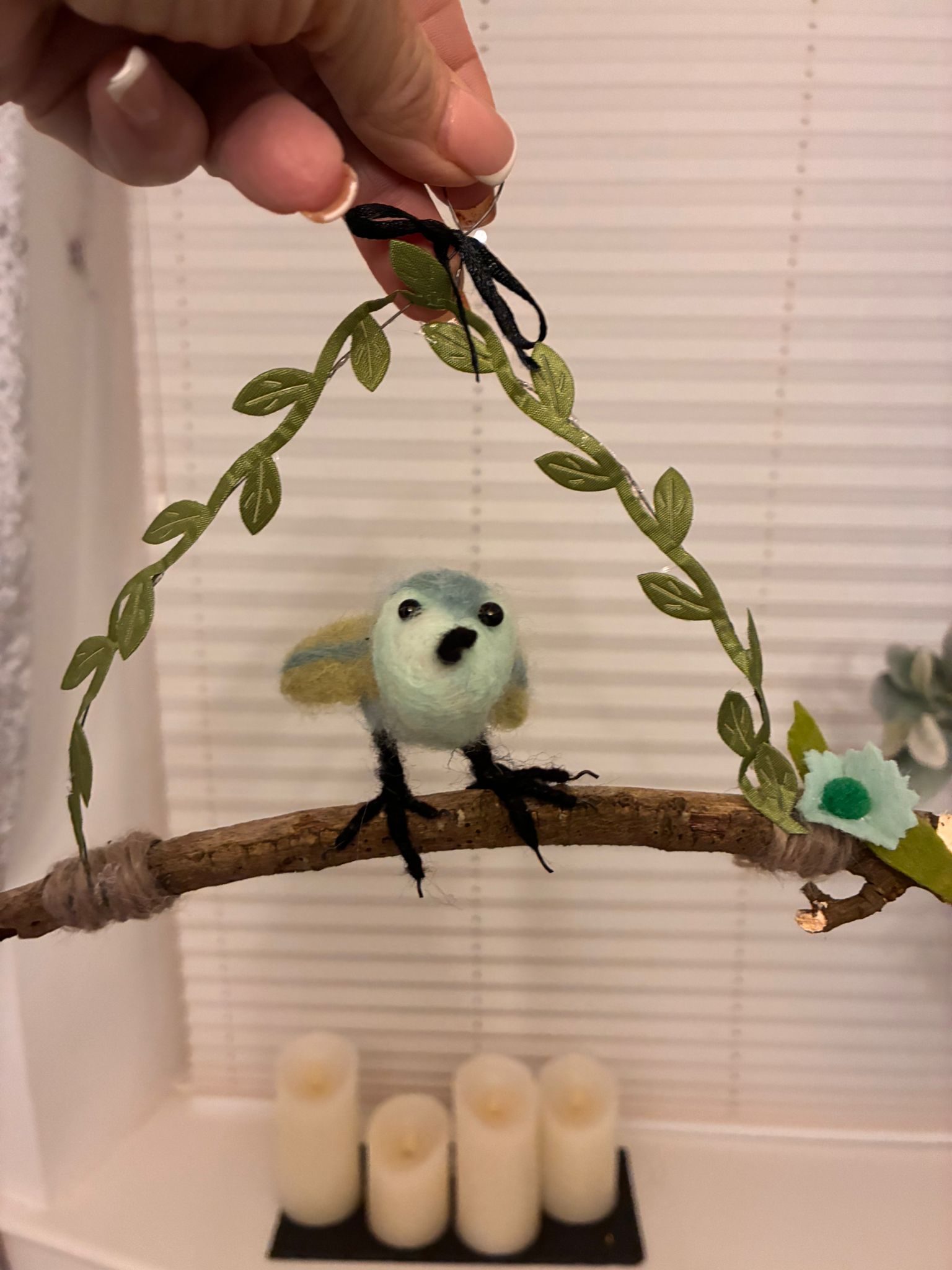 Needle felt bird on twig with leaf garland