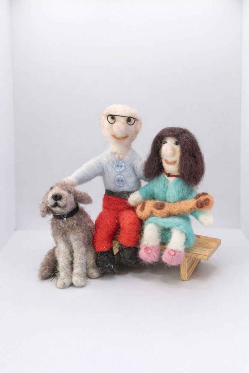 Needle felt couple sitting on bench with their dog