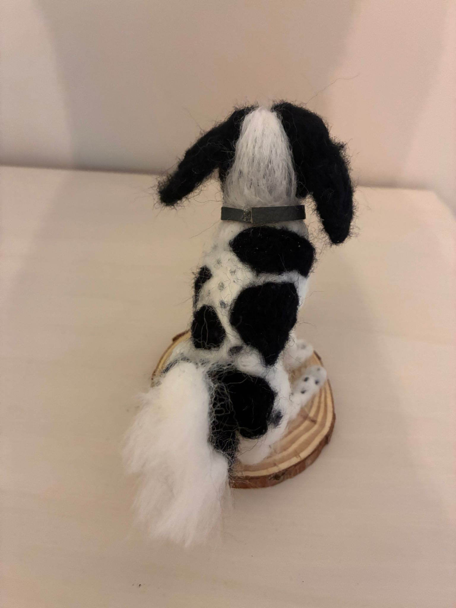 Needle felt black and white dog, back view