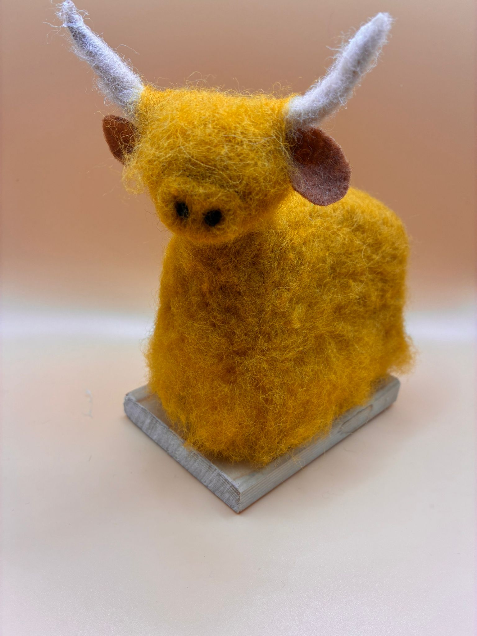 Needle felt large highland cow on wooden base