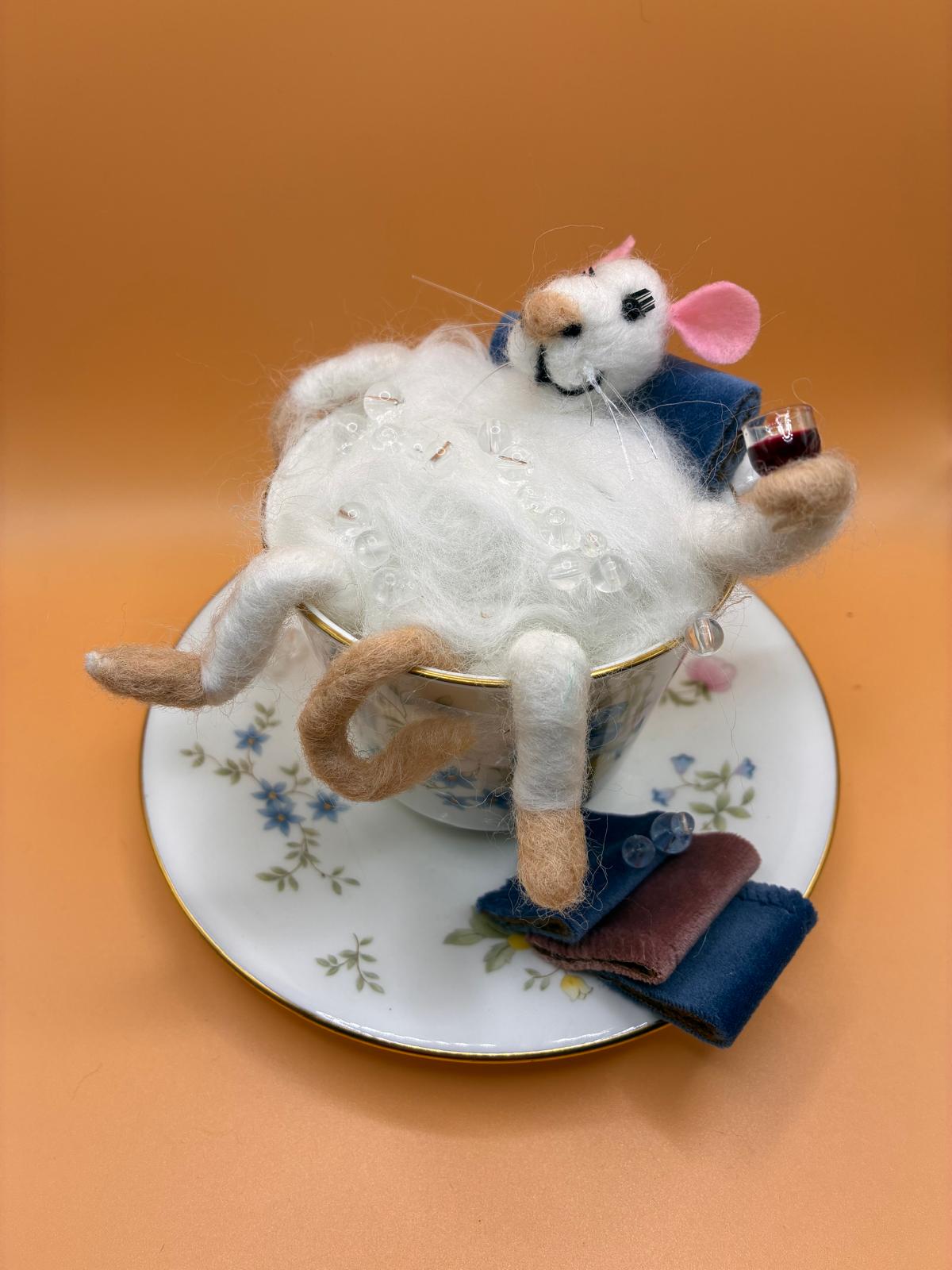 Needle felt mouse relaxing in vintage teacup holding a glass of wine