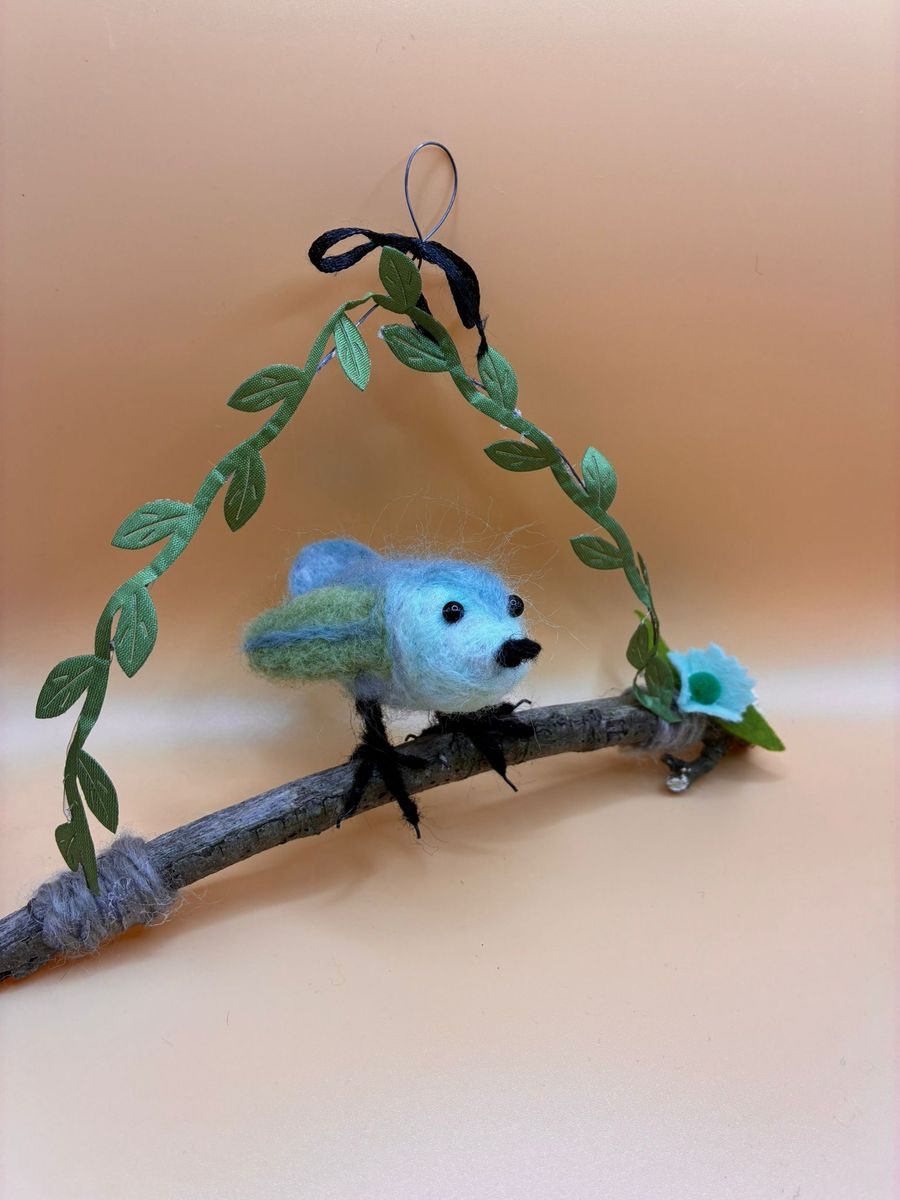 Needle felt blue bird on hanging twig with leaf garland