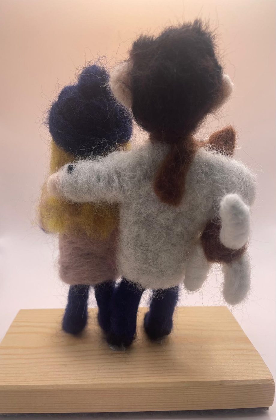 Needle felt couple from behind holding cat