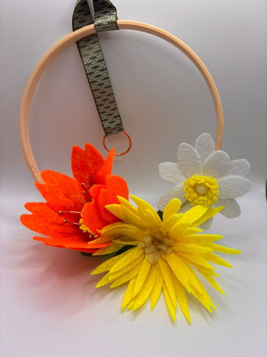 Felt orange and yellow flowers on embroidery hoop
