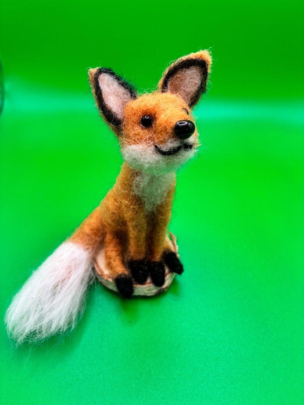 Smiling fox on a wood slice